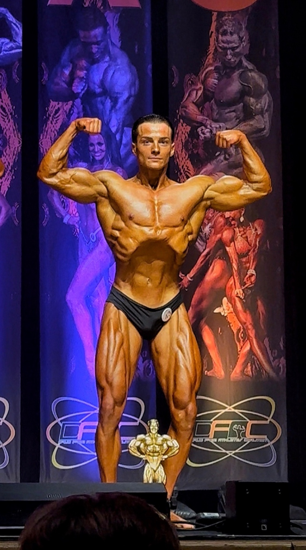 Stefan Gorgiev on stage, front double biceps pose